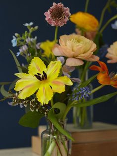 a vase filled with lots of different colored flowers