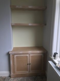 an empty shelf in the corner of a room