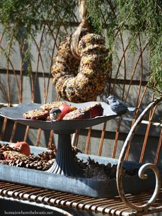 two trays filled with food sitting on top of a metal bench next to a tree