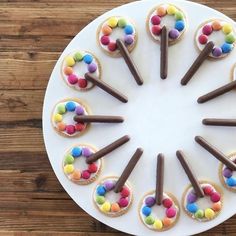 a white plate topped with cupcakes covered in candy