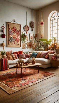 a living room filled with lots of furniture next to a large window and potted plants