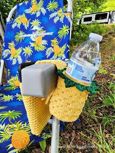 a crocheted chair with a water bottle on it and a pineapple cover