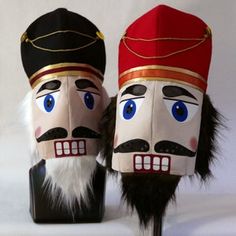 two nutcrackers with hats and tails on top of each other in front of a white background