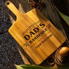 a wooden cutting board with the words dad's barbeque engraved on it