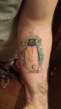 a man with a penguin tattoo on his leg