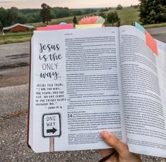 someone is holding up a book with the words jesus is the only way