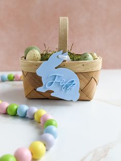 a basket filled with eggs and an easter bunny decoration