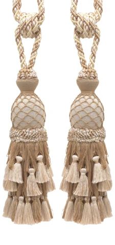 pair of earrings with tassels on white background