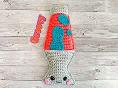 a crocheted stuffed animal laying on top of a white wooden floor next to a sign that says goooo