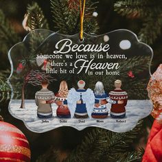 an ornament hanging from a christmas tree with three angel figurines on it