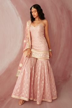 Blush pink short kurta with gota patti trims and side slits. Comes with sharara and dupatta. Component: 3 Pattern: Embroidery Type Of Work: Gota Patti Neckline: Sweetheart Sleeve Type: Sleeveless Fabric: Silk Chanderi Color: Pink Other Details:  Dupatta with gota patti border Side slits Occasion: Wedding - Aza Fashions Pink Indian Outfit, Sureena Chowdhri, Pink Sharara, Floral Dresses With Sleeves, Sharara Designs, Haldi Outfits, Kurta Sharara Set, Western Dresses For Women, Kurta Sharara