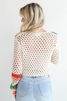 You'll be ready for dreamy days in the sun when you've got the Vibrant Crush Ivory Crochet Knit Top! This top features an array of bright, cheerful colors woven into an intricate crochet knit pattern, creating a unique, eye-catching design that adds texture and personality to any outfit. The button-front style offers versatility and ease of wear, allowing you to style it open over a tank or buttoned up for a more polished look. Crafted from soft, breathable yarn, this top provides comfort while White Bohemian Knit Top For Summer, Multicolor Open Knit Sweater For Vacation, Multicolor Knitted Sweater For Vacation, Knitted Multicolor Sweater For Vacation, Bohemian Multicolor Sweater For Beach, Bohemian Multicolor Beach Sweater, Multicolor Bohemian Beach Sweater, Multicolor Open Knit Beach Sweater, Bohemian Open Knit Sweater For Summer