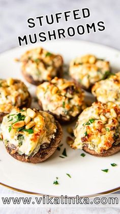 small stuffed mushrooms with cheese and herbs on a plate