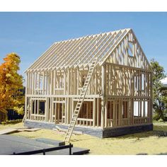 a house under construction with a ladder going up to the roof