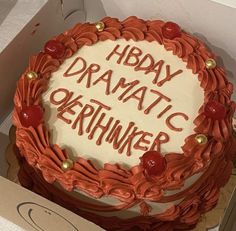 a birthday cake in a box with the words hbday dramatic okernhuner written on it