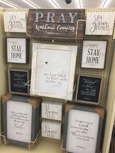 a display in a store filled with framed pictures and sayings on it's walls