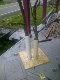 two tall vases sitting on top of a wooden table next to a park bench