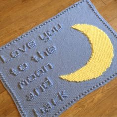 a blue and yellow rug with a crescent on it