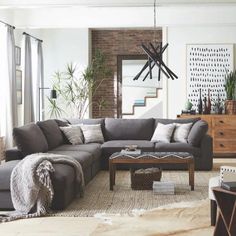 a living room filled with lots of furniture next to a tall clock mounted on the wall