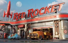 an old red rocket shop with cars parked in front