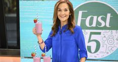 a woman holding two smoothies and strawberries in front of a fast 5 sign