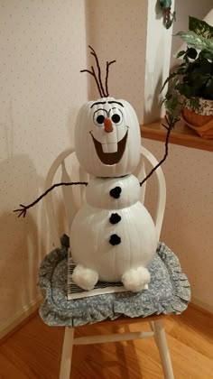 a snowman sitting on top of a chair