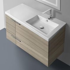 a white sink sitting under a mirror next to a wooden cabinet