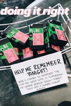 a bunch of pink and green tags are on a wire with a sign that says help me remember tonight