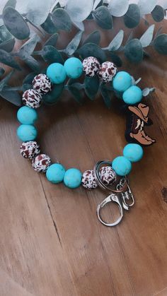 a bracelet that has some beads on it and a keychain attached to it