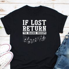 a t - shirt that says if lost return to band room, with music notes on it