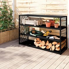 a black shelf filled with lots of different types of gardening tools on top of a wooden deck