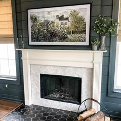 a fireplace with a painting on the wall above it