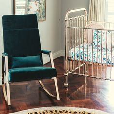 a baby crib and rocking chair in a child's room with hardwood floors