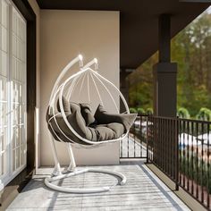 a white swing chair sitting on top of a balcony