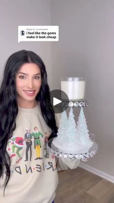 a woman holding a cake with frosting on it