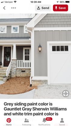 a gray house with white trim and windows