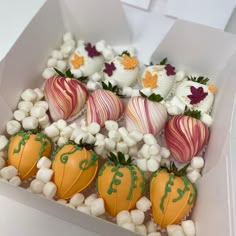 a box filled with chocolate covered strawberries and marshmallows