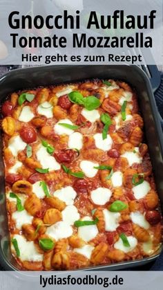 a square casserole dish with tomatoes and mozzarella on top in a pan