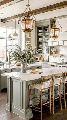 a large kitchen with an island in the middle and lots of chairs on top of it