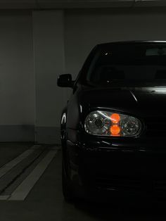 a black car parked in a parking garage