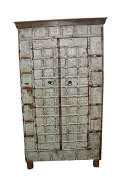 an old wooden cabinet with metal doors on the top and bottom, against a white background