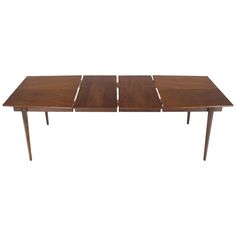 a wooden table with four leaves on it