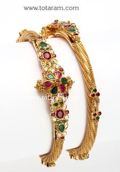 22 Karat Fine Gold Kada with Ruby,Emerald & Cz - Set of 2 (1 Pair).
   Width at the Center of the Kada: 19.0 mm

  Note: This item comes with a Screw and hinge so that you can open it up for easy wearing.        - 235-GK339 - in 40.600 Grams for USD $3475.79. 
Made in India by Totaram Jewelers Online this product is in Gold - 22 Karat BIS Hallmark 916 KDM Gold  & is an excellent gift for Adult - Women. Ships fully insured with secured guaranteed delivery for free with your order over $25 Ruby Jewelry Necklaces, Gold Kada, 22k Gold Bangles, Temple Jewellery Earrings, Indian Gold Jewelry, Gold Bangles Indian, Bridal Necklace Designs, Gold Bangles For Women, Diamond Bracelet Design