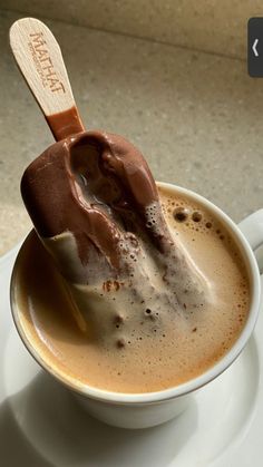 a cup of hot chocolate with a spoon in it