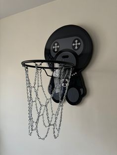 a wall mounted basketball hoop with chains hanging from it's sides and a cartoon face on the back