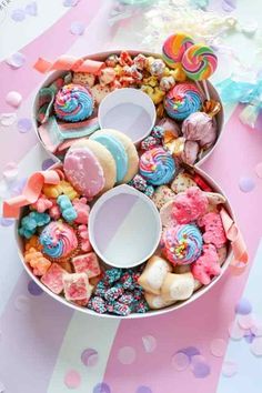 a bowl filled with lots of different types of donuts and sprinkles