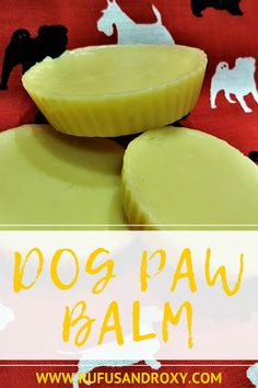 two slices of dog paw balm sitting on top of a red table cloth with black and white horses in the background