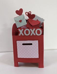 an origami valentine's day card box with hearts and envelopes in it