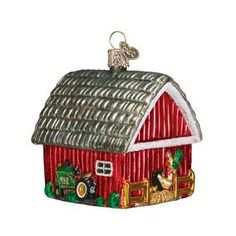 an ornament shaped like a barn with a tractor and farm animals on it