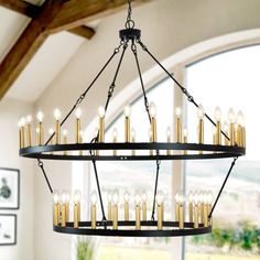 a large chandelier with many candles hanging from it's centerpiece in a living room